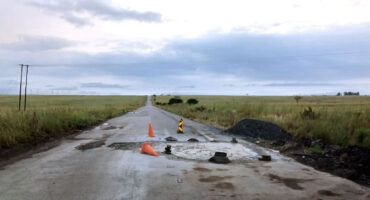 Image showing damage road surface on the R33 between Dundee and Vryheid with cones one of which is lying down.