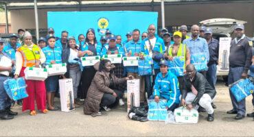 Image of blue clad community SAPS patrollers (volunteers) with Umzinyathi SAPS management.