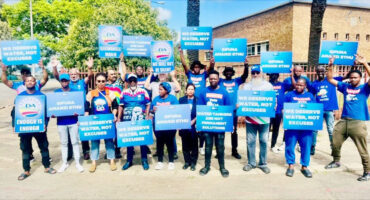Blue-clad DA supporters carrying placards protest against ongoing water outages.