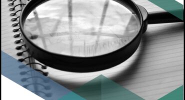 Image of a magnifying glas looking at an audit report.