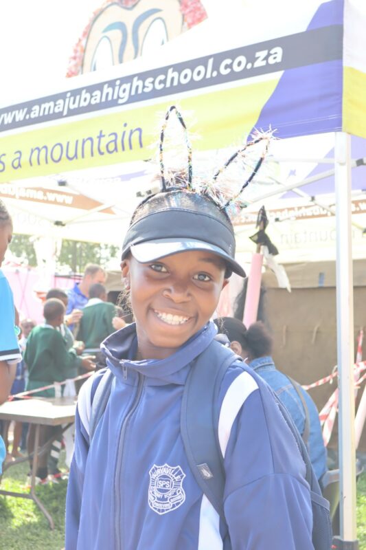 A young child is photographed having fun at a local fair.