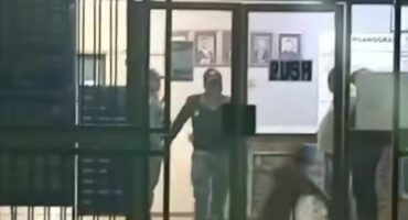 A screenshot of a video allegedly showing a police officer in Volksrust assaulting a man.