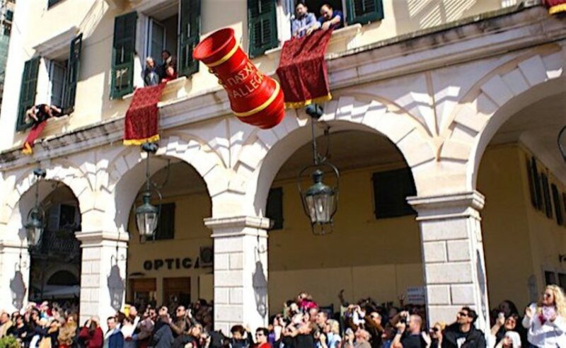 Residents in the town of Corfu in Greece, throwing a big red and yellow pot out of their window.