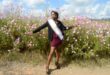 Image of model Nomcebo Ntombela among the cosmos flowers in the Dundee area.