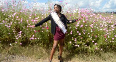 Image of model Nomcebo Ntombela among the cosmos flowers in the Dundee area.