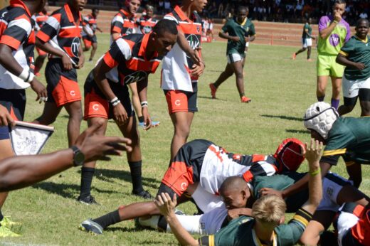 Image of Dundee High and Vryheid High rugby players on the field of play.