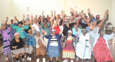 A photo of a group of elderly people seemingly very excited for their get-together at the Fairleigh community hall.