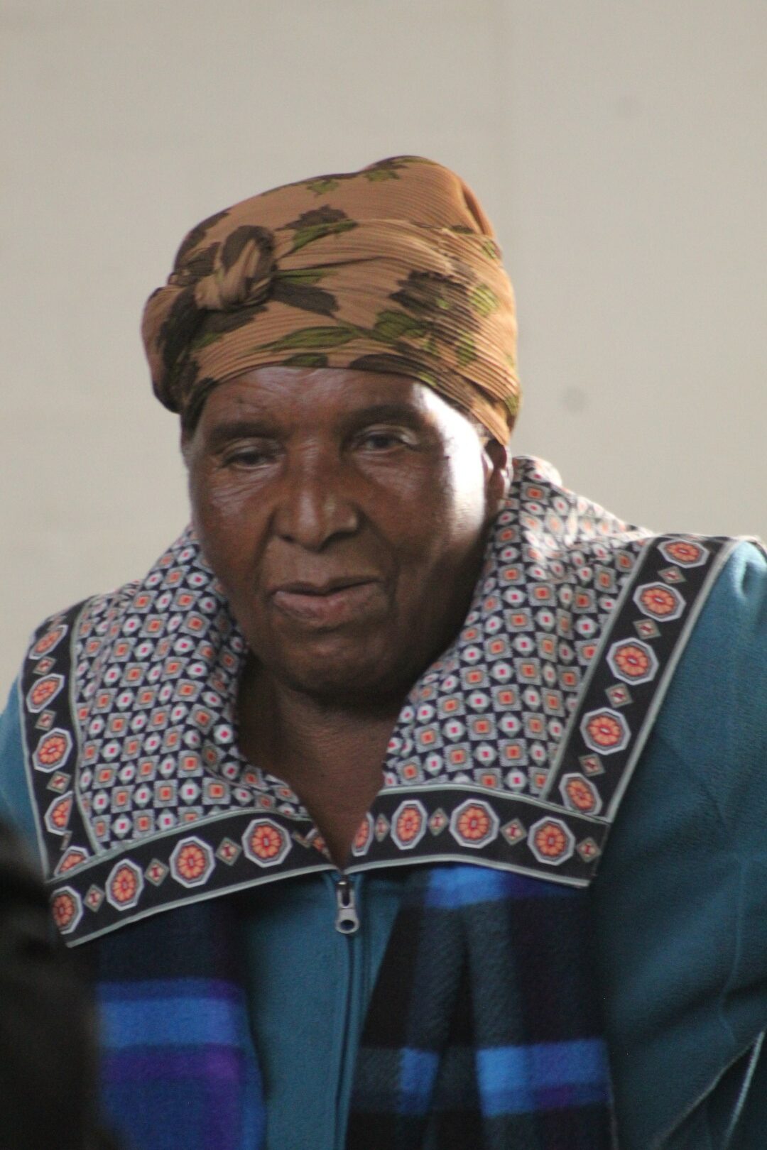 A woman is photographed dancing inside a community hall.