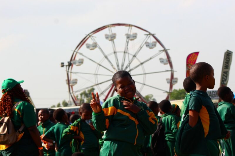 A young child is photographed having fun at a local fair.