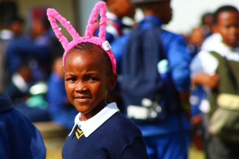A young child is photographed having fun at a loal fair.