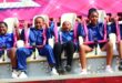 A group of school children dressed in blue uniforms are visibly scared while on a carnival ride.