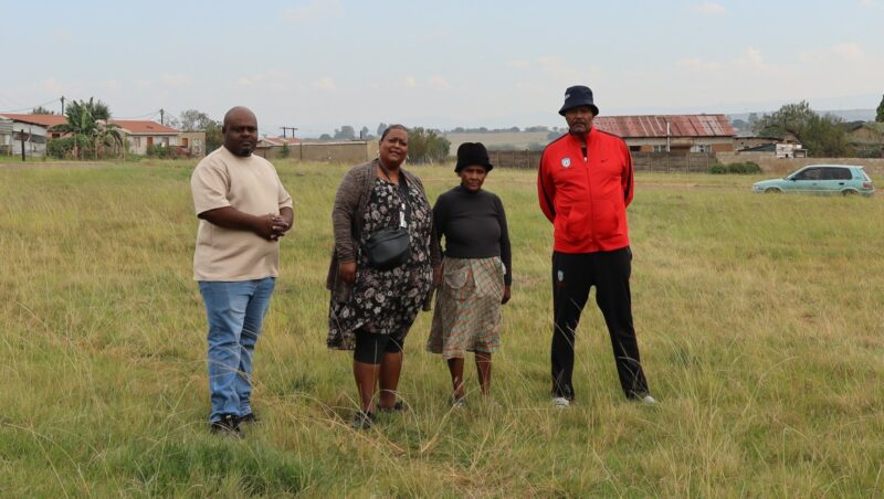 A group of four people stand between Fairleigh and Siyahlala-la in Newcastle.