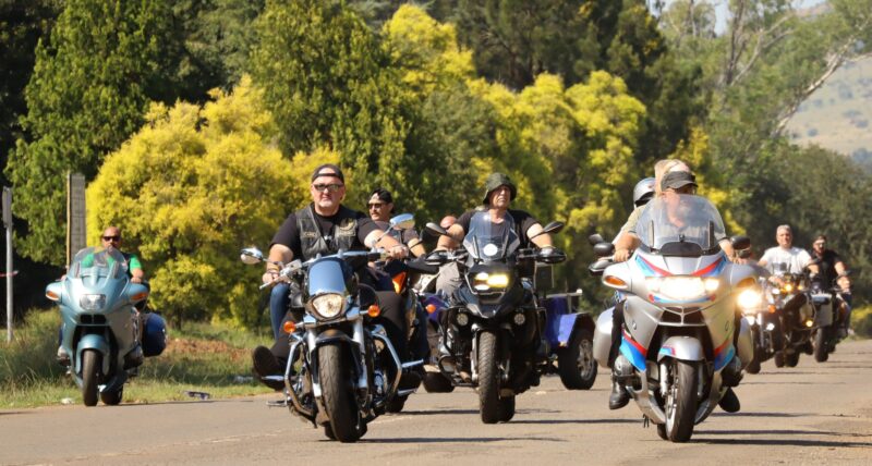Group of bikers ride together on open road
