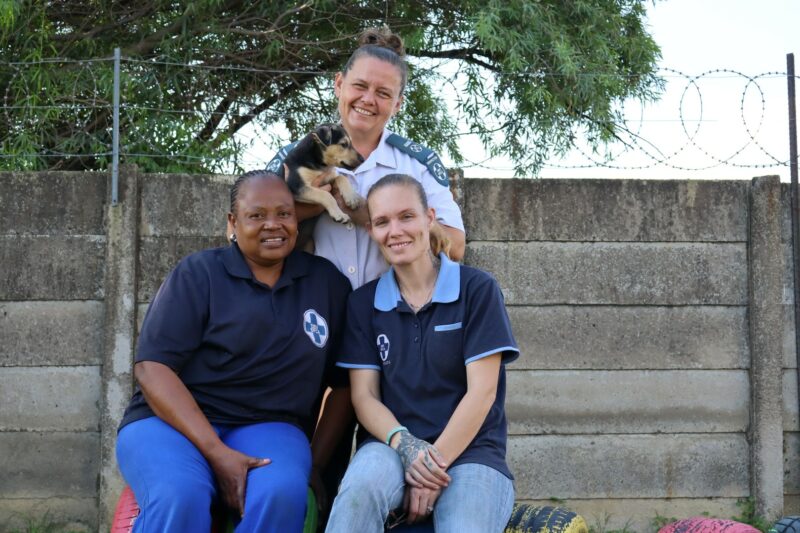 Two SPCA staff members and inspector Jenavieve with a puppy, Zama.