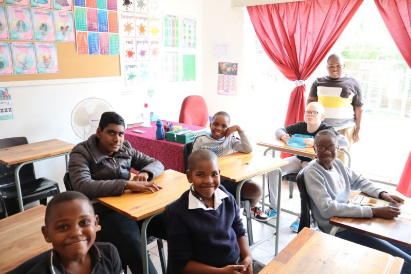 Student in a classroom sitting at their desks.