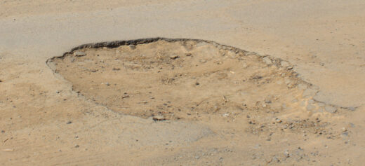 Close up image of a big pothole in Dundee, McKenzie Street.