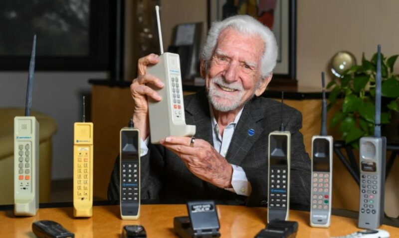 Martin Cooper, the first man to make a call on a cellphone, with a collection of old cellphones.