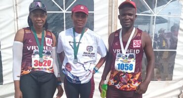 Image of runners from Vryheid Athletic Club after a race with their medals.