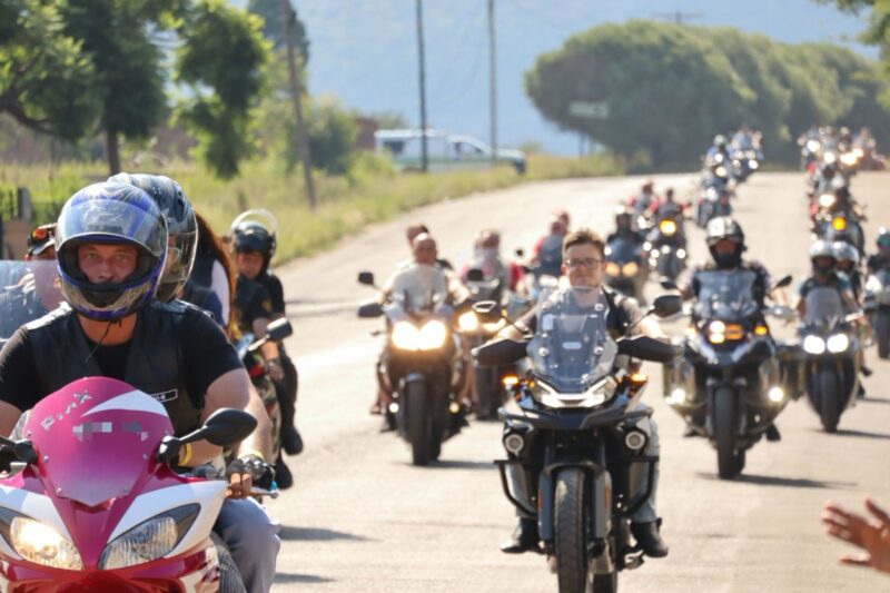 Group of bikers ride together on open road