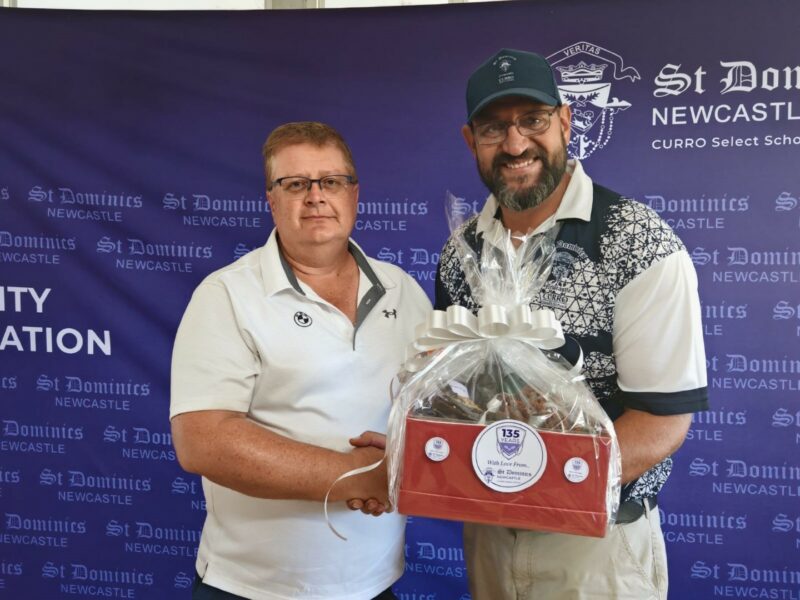 Louis Kruger and head of High School, Etienne Smith holding a prize.