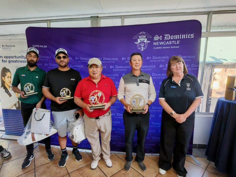 The top three teams for the golf day stadning next to Executive Head of School, Mrs Shirley McGhee.