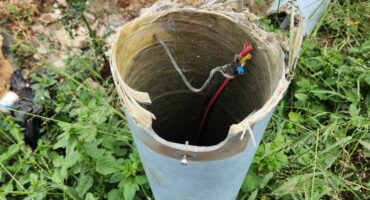 A broken street light with the wires cut.