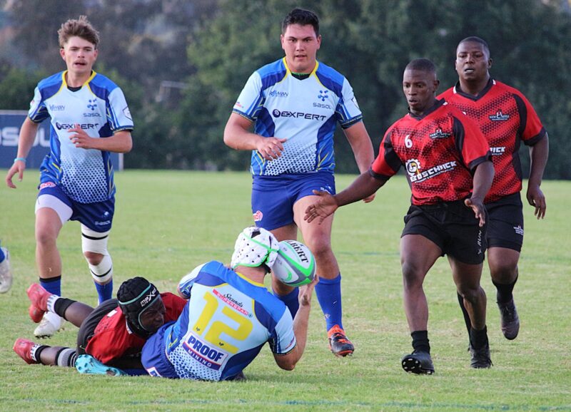 two rival rugby teams face off on a rugby field.