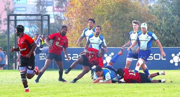 two rival rugby teams face off on a rugby field.