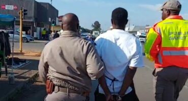 An image of two public safety officials from AbaQulusi after arresting an undocumented immigrant during the CBD operation.