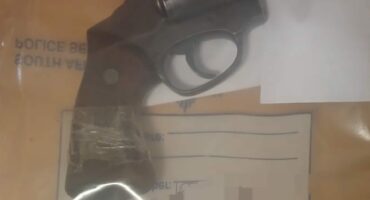 Image of a .38 Special revolver along with ammunition on a table in plastic.