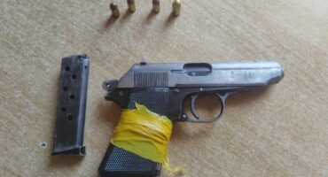 Image of a pistol with a magazine and ammunition/