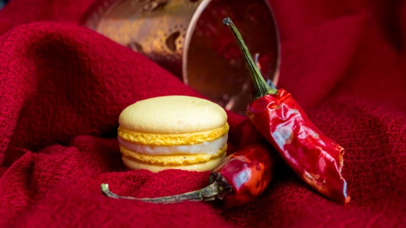 Yellow macaron with chilli peppers composition
