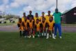 An image of little boys who play for Vryheid Sundowns FC with their coach Zweli Hlatshwayo.