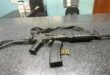 Image of R5 rifle and ammunition displayed on a SAPS charge office.