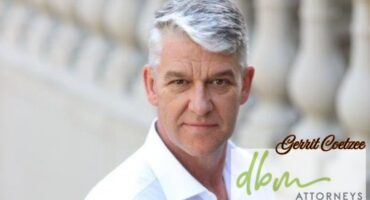 A professional portrait photo taken of a grey-heaired man. The DBM Attorneys logo is written in bold light green and the man's name, Gerrit Coetzee is written in bold black writing.