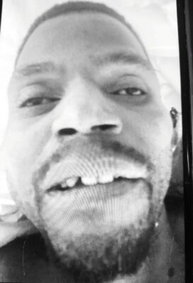 Image in black and white of deceased man.