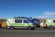 A photo of two ambulance fleets and a municipal truck along side the road.