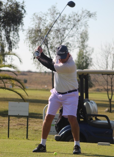 A golfer is photographed in action on the greens.
