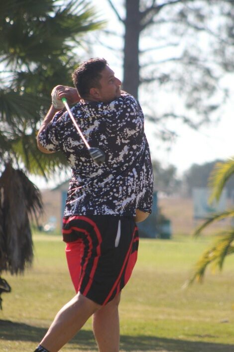 A golfer is photographed in action on the greens.