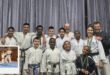 A photo of a large group of karateka and their trainers.