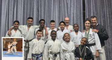 A photo of a large group of karateka and their trainers.