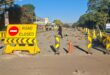 Image of a closed road with signage.