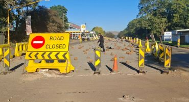 Image of a closed road with signage.