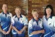 Two photos with two players in each photo wearing blue and white bowls attire and posing in front of a brown, brick wall.