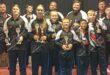 A photo of the Newcastle athletes holding trophies and their coaches who particptaed at the recent WAKO Kickboxing Championships