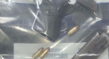 Image of ammunition and a firearm in an evidence bag.