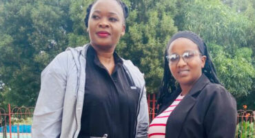 Image of Penelope Mlangeni (psychologist) and Zamatubgwa Khumalo (health promoter practitioner) next to a swimming pool.