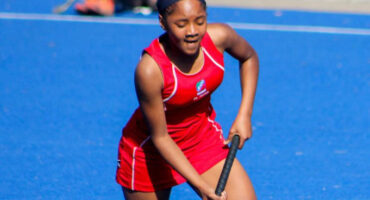 An image of Anesu Sithole on the hockey field holding a hockey stick. She is a grade 8 hockey star has been selected for Netherlands tour and seeks financial help.