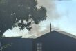 Image of smoke rising from a protest action on Smith Street, Dundee, near the Eventide Home for the aged.