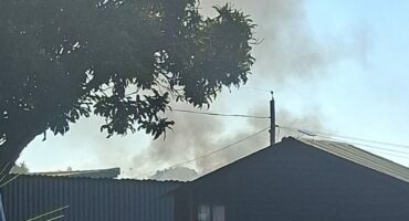 Image of smoke rising from a protest action on Smith Street, Dundee, near the Eventide Home for the aged.